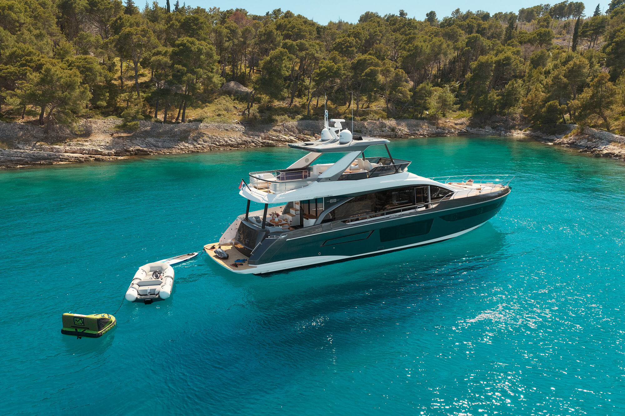 Pangea anchored in a turquoise bay beside a Dalmatian island