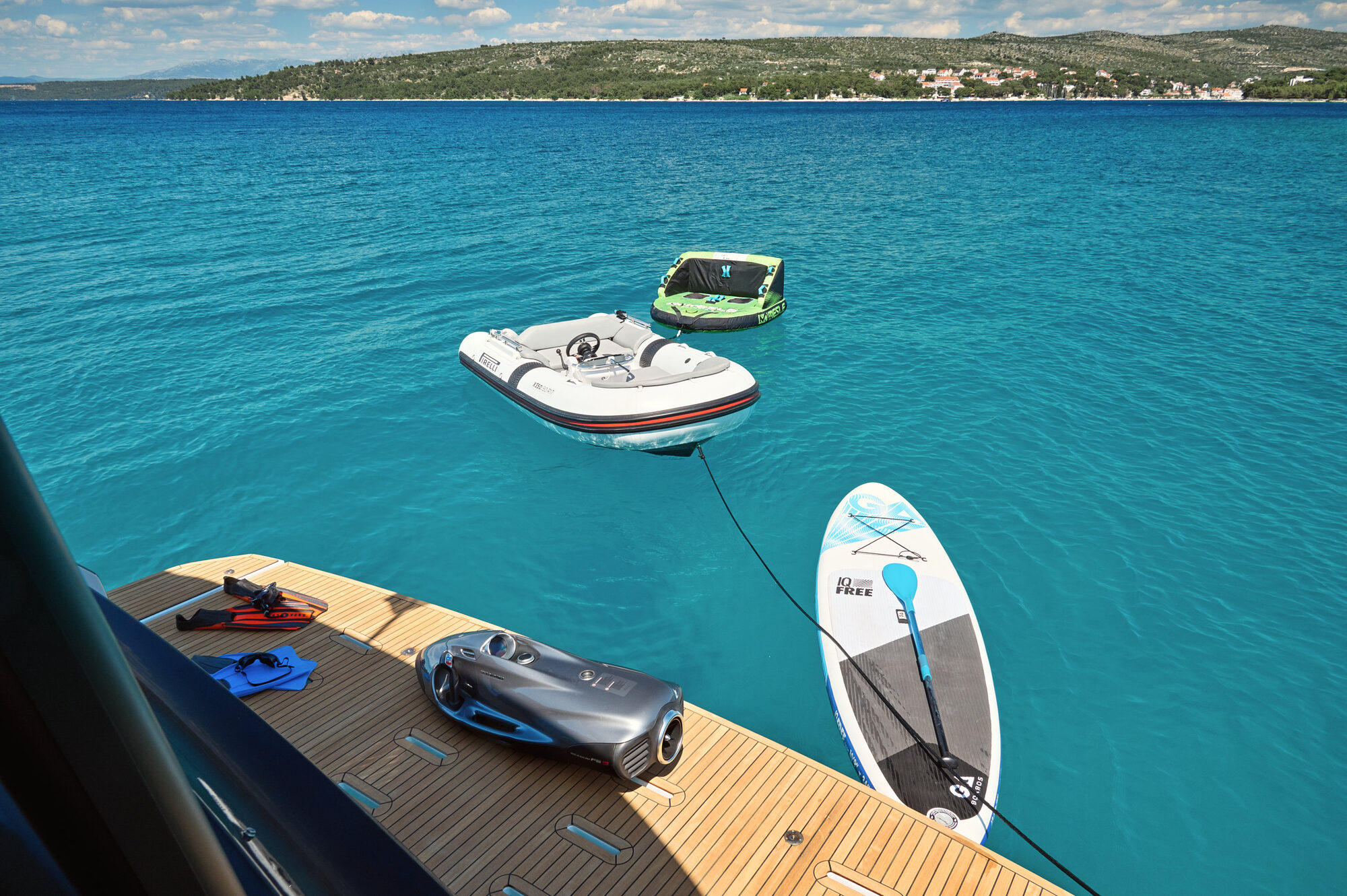 Teak swim platform at the waterline with water toys